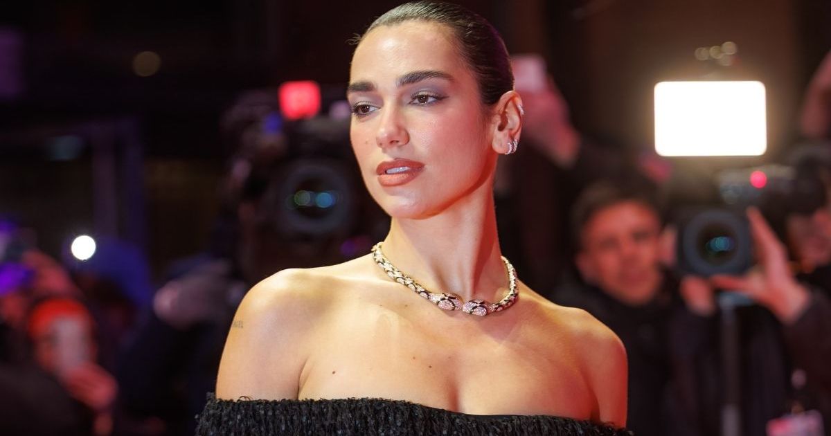 Dua Lipa’s Crisp White Shirt Hangs on by a Button for Bulgari