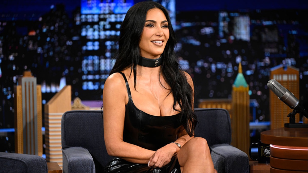 Kim Kardashian in a black SKIMS triangle bikini campaign photo 2026