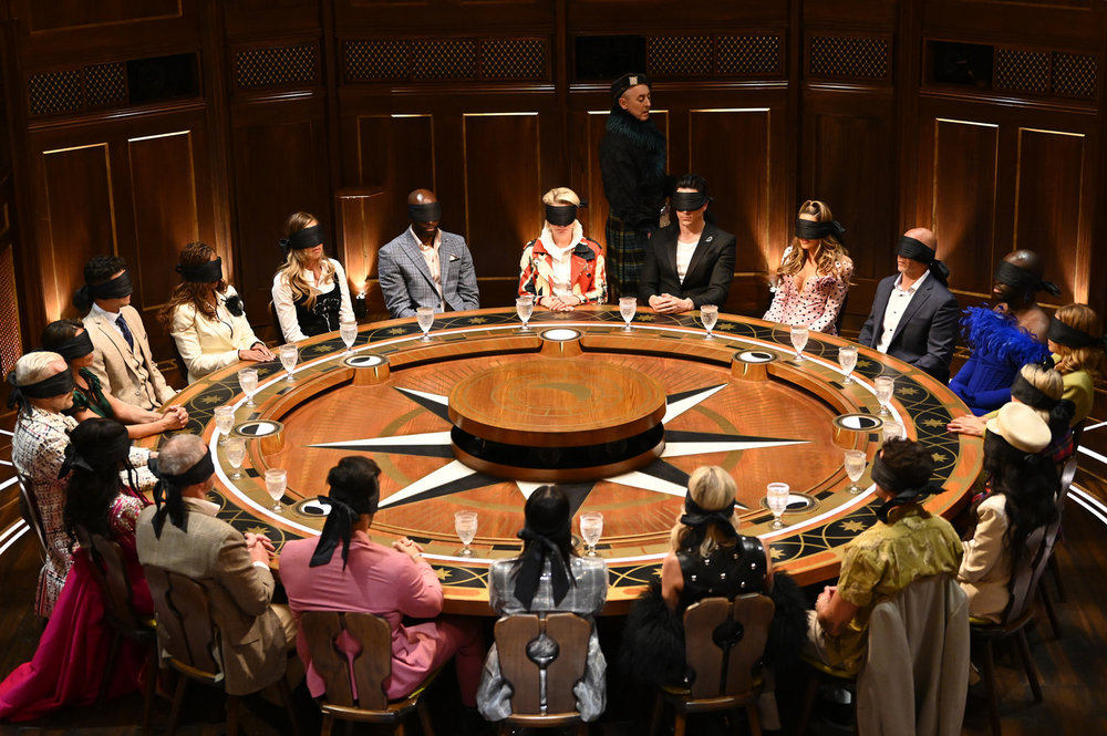 Players sitting around the roundtable with blindfolds on The Traitors Season 3