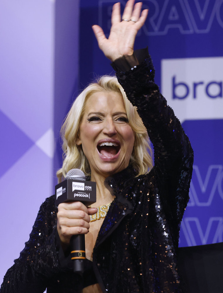 Dorinda Medley in a sparkly black top, waving and holding a microphone at BravoCon 2025 