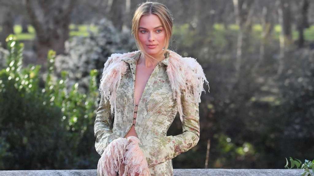 Margot Robbie Layers Miniskirt & Sheer Tights Under Bold John Galliano Coat