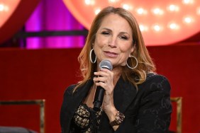 Jill Zarin in a black blazer on stage at at Bravo Con 2022 talking into a microphone