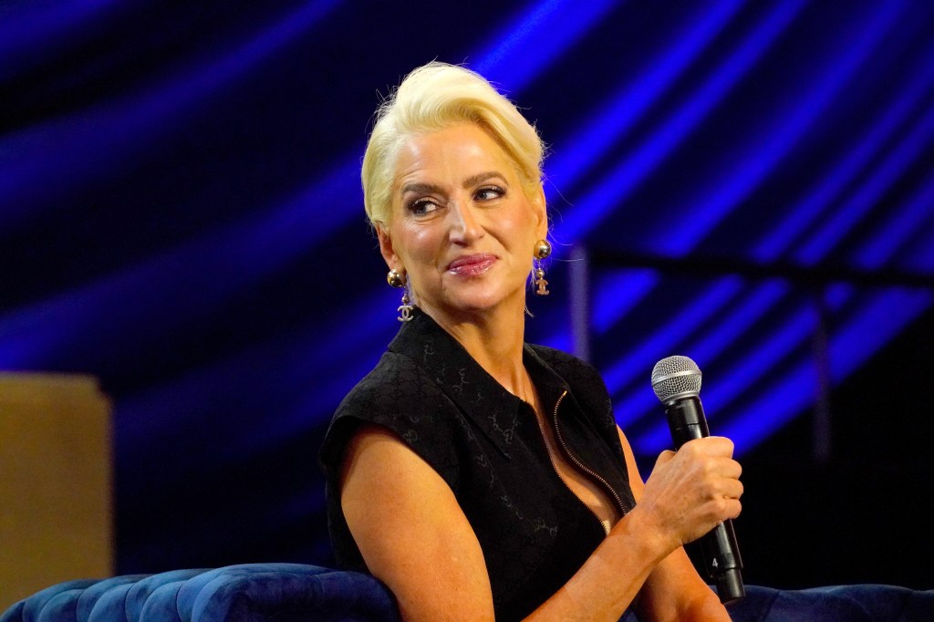 Dorinda Medley in a black dress, holding a microphone at BravoCon 2023