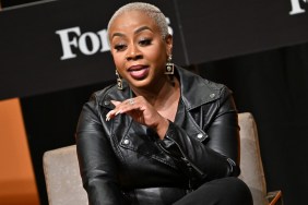 Pinky Cole in a black leather jacket speaking at Forbes event