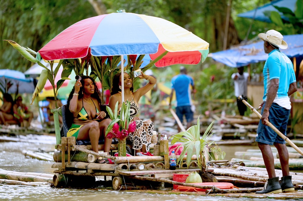 Quad Webb and Angel Love Davis floating down a river in Jamaica