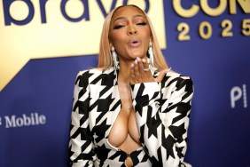 Drew Sidora in a houndstooth dress, blowing a kiss at BravoCon 2025