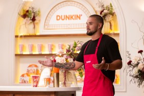 Chase McWhorter in a Dunkin Donuts apron shrugging his shoulders