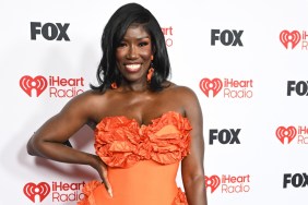 Bozoma Saint John in an orange dress with her hand on her hip