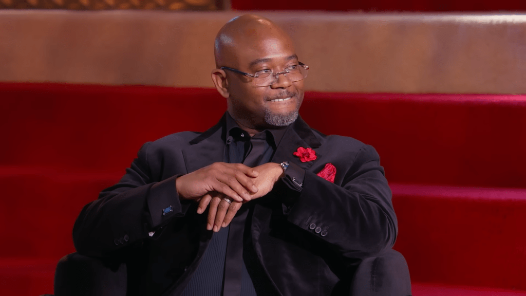 Dr. Eugene Harris biting his lip at the Married to Medicine Season 12 reunion