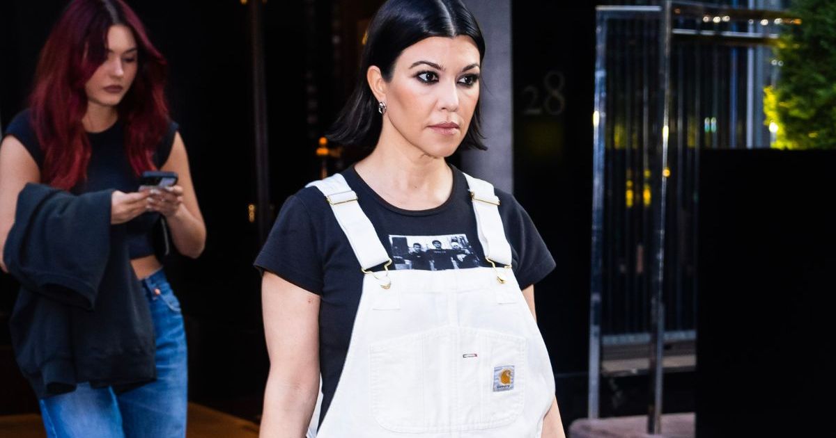 Kourtney Kardashian Poses in a Slip Dress & Sheer Socks in Bed for Lemme