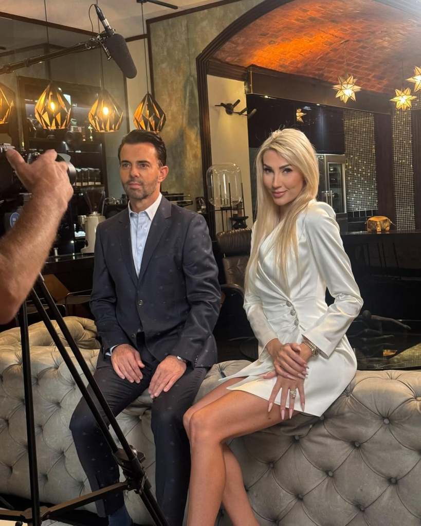 Peet and Mel Viljoen sitting on a couch in front of a camera crew