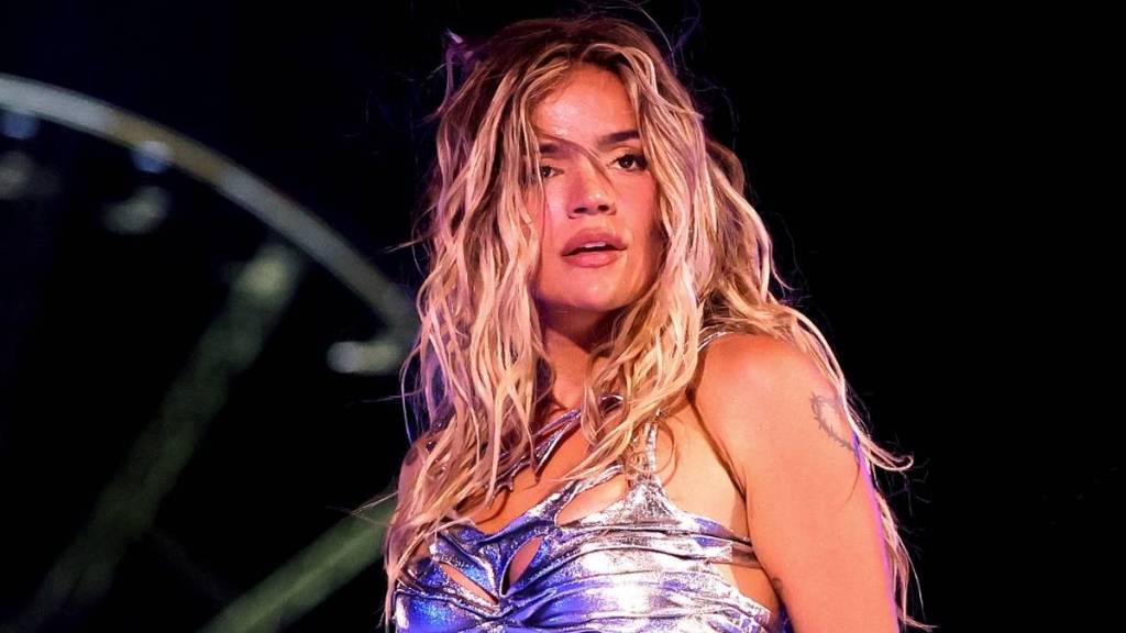 Karol G Debuts Bold Tank Top & Micro Shorts Look in New Tour Announcement Video