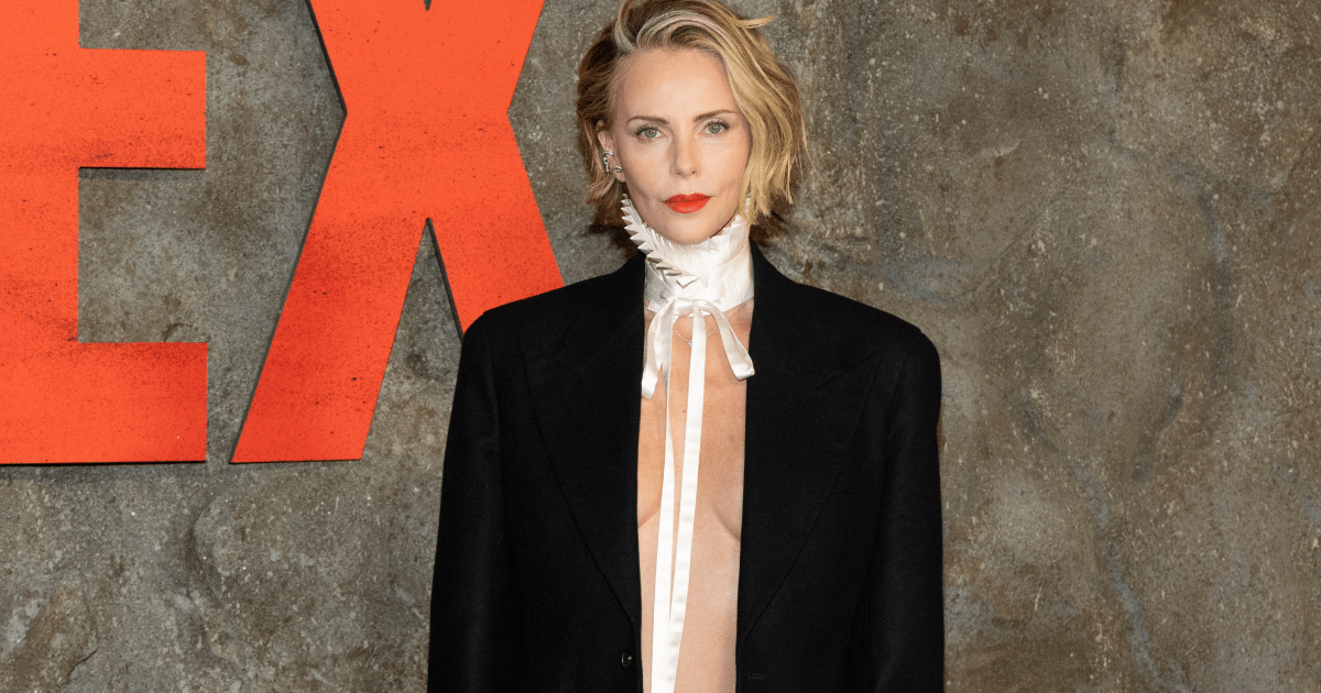 Charlize Theron Goes Topless & Braless Under Power Suit