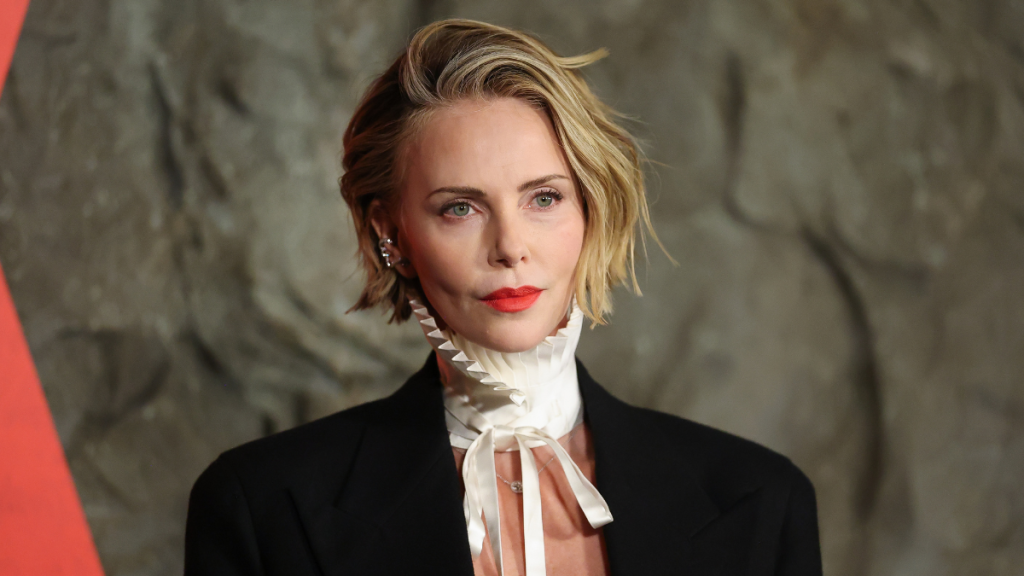 Charlize Theron Goes Topless Under Men's Jacket for Apex Premiere