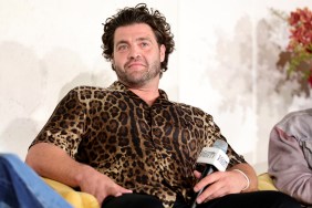 CT Tamburello in a leopard print shirt holding a microphone