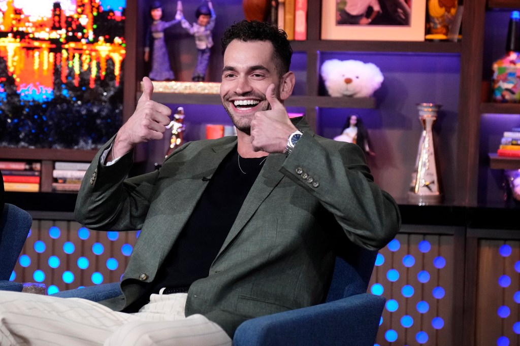 Jesse Solomon in a green jacket, giving two thumbs on Watch What Happens Live