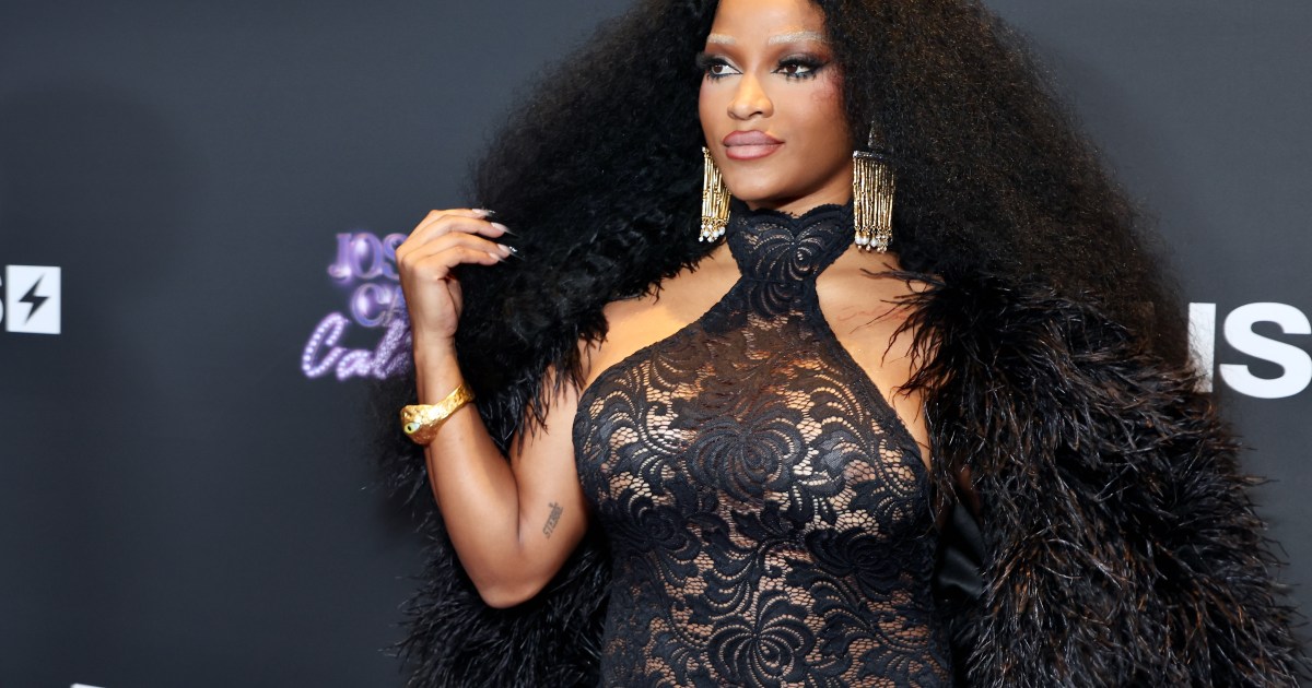 Joseline Hernandez wearing all black and a fur cape at the Joseline's Cabert California premiere