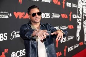 Ronnie Ortiz-Magro in a blue jacket and sunglasses at the VMAs, pointing both hands at the camera