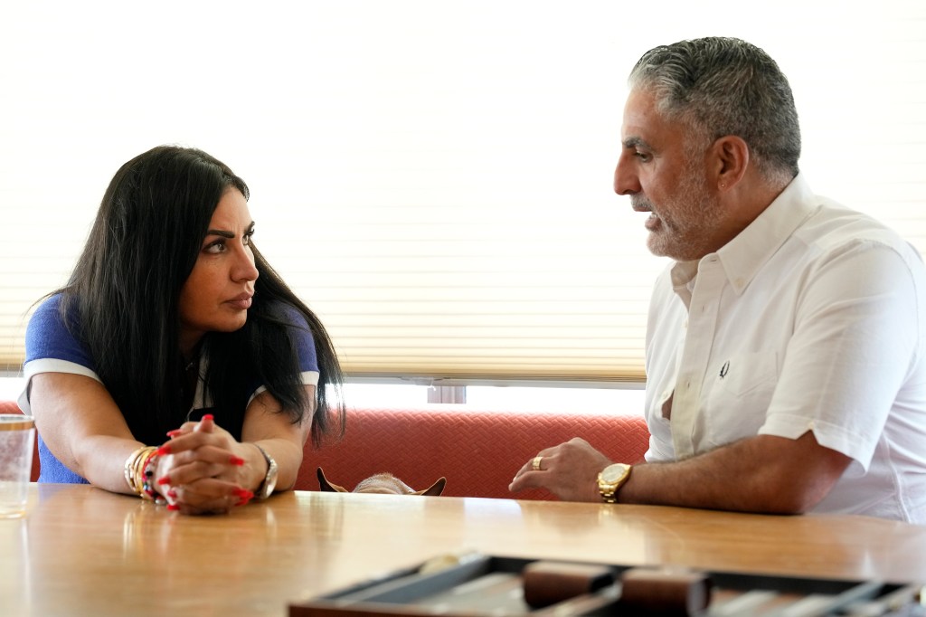 Mercedeh Javid and Reza Farahan looking at each other across a table