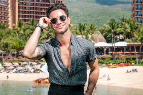 Sasha Farber posing in front of a beach wearing sunglasses