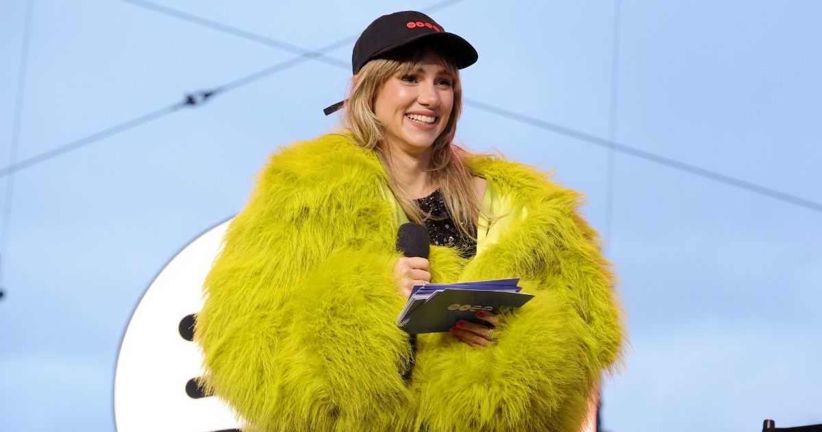 Suki Waterhouse Goes Edgy in Leather Thong & Fishnets for New MV