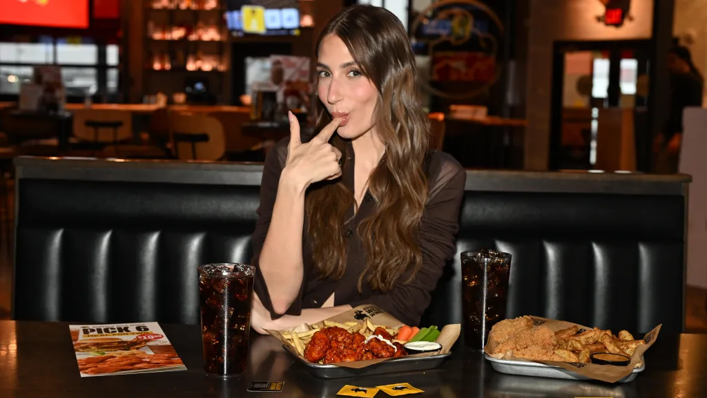 Amanda Batula at Buffalo Wild Wings with her finger in her mouth