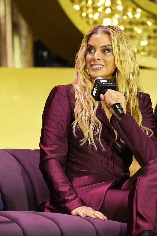 Robyn Dixon in a red suit on stage at BravoCon 2025