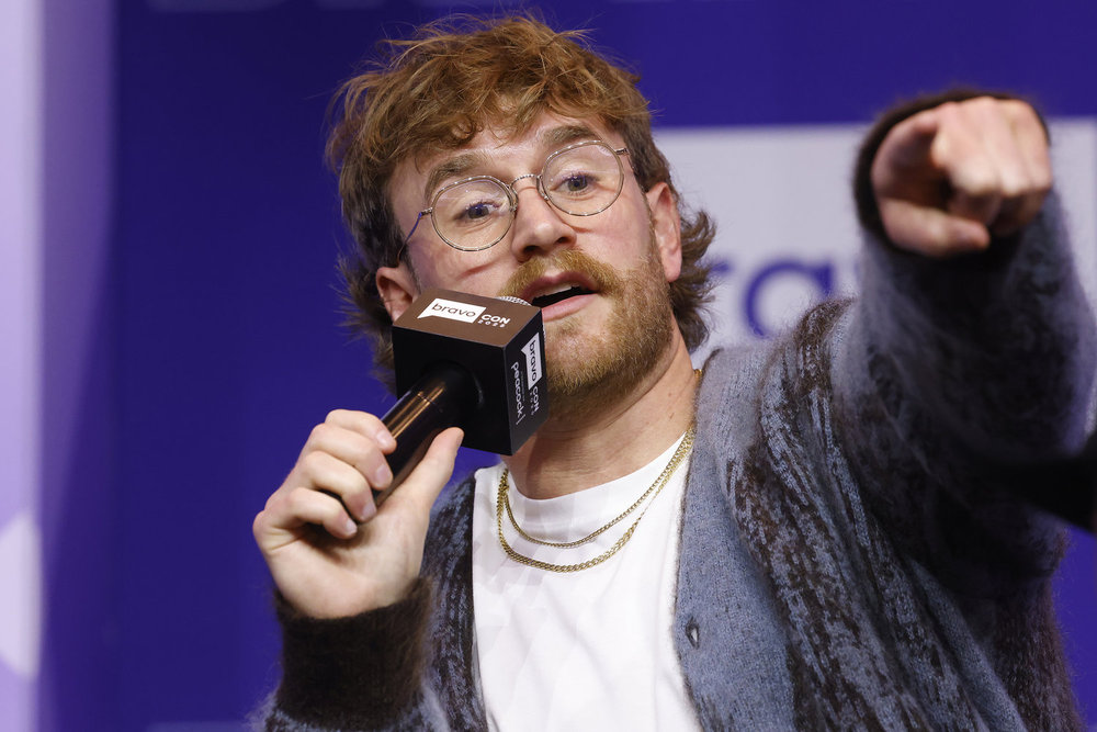 West Wilson pointing his finger and holding a microphone at BravoCon 2025