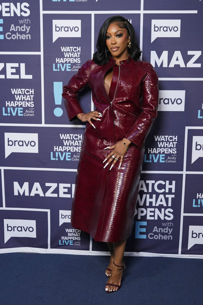 Porsha Williams in a red leather dress, posing backstage at Watch What Happens Live