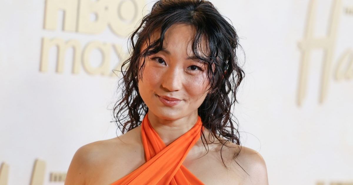 Poppy Liu’s Fiery Orange Cut-Out Dress Turns Heads at Hacks Season 5 Red Carpet
