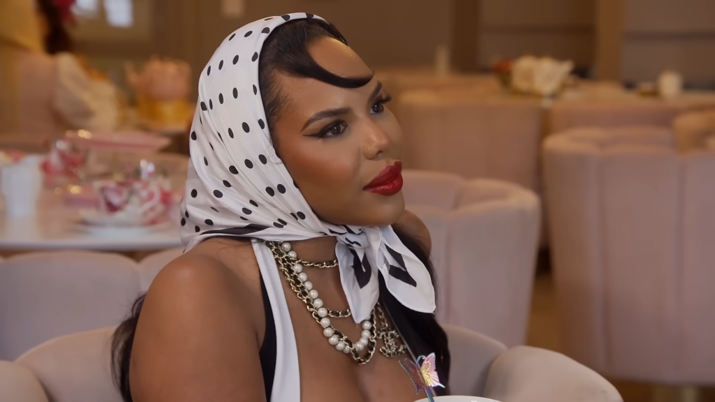 Kelli Ferrell in a black and white polka dot headscarf wrapped