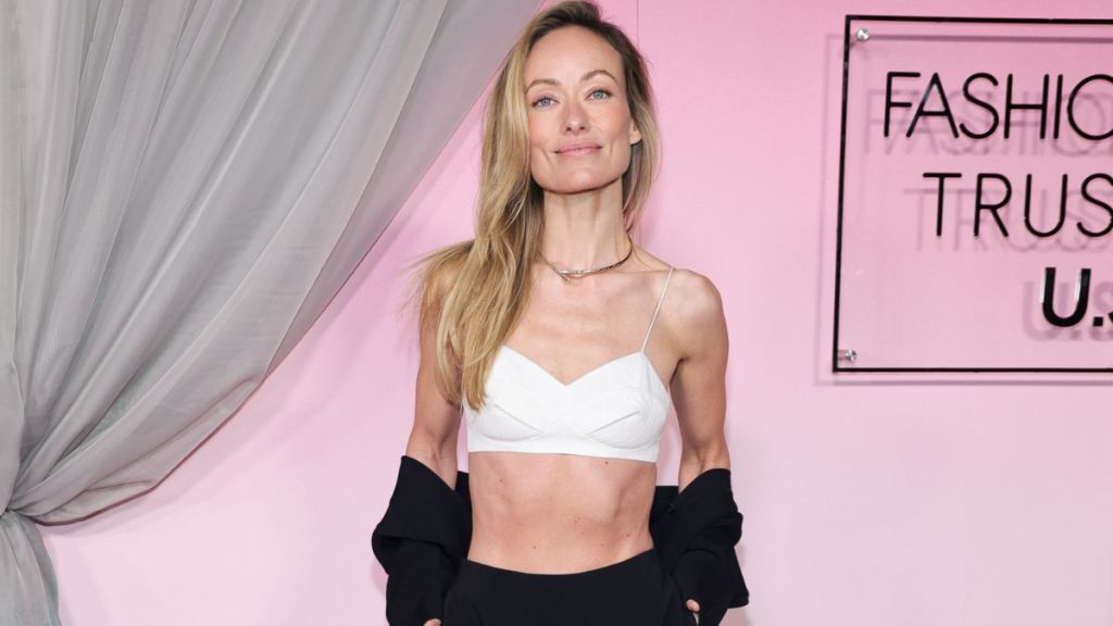 Olivia Wilde's Ashlyn Micro Crop Top Hangs by Strings Over High Slit Skirt