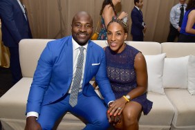 Marcellus Wiley in a blue suit sitting on a couch with wife Annemarie Wiley