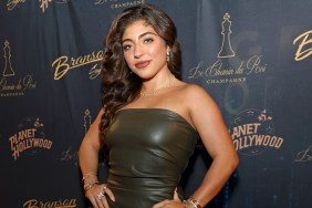 Melania Giudice standing in a green dress with her hands on her hips