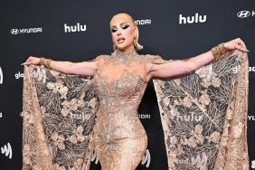 Plane Jane at the GLAAD Media Awards holding out a golden cape