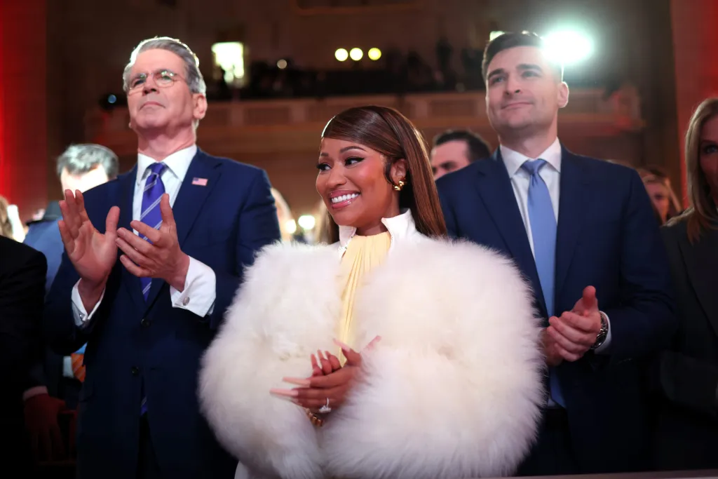 Treasury Secretary Scott Bessent (L) and Musician Nicki Minaj (C) applaud as they attend the Treasury Department's Trump Accounts Summit at Andrew W. Mellon Auditorium 