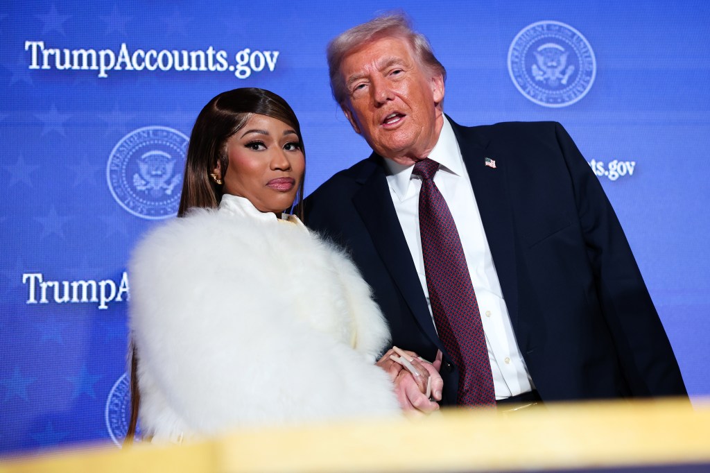 Nicki Minaj embracing and holding hands with Donald Trump on stage