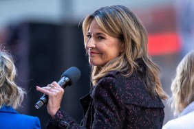 Savannah Guthrie holding a microphone and looking over her shoulder in a blue and pink coat