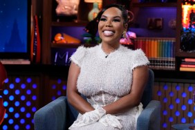 Kelli Ferrell in a white dress with her hands on her lap on Watch What Happens Live