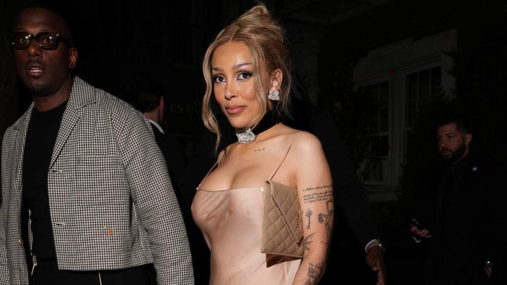 Doja Cat Shows off Cleavage in Nude Dress Held by the Thinnest Strings