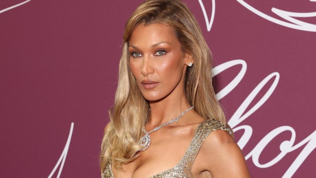 Bella Hadid stuns in a plunging see-through dress at the Cannes Chopard Gala. Discover her vintage Elie Saab fashion moment.