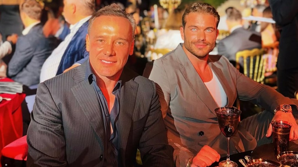 Lenny Hochstein and a friend sitting at a table at a gala