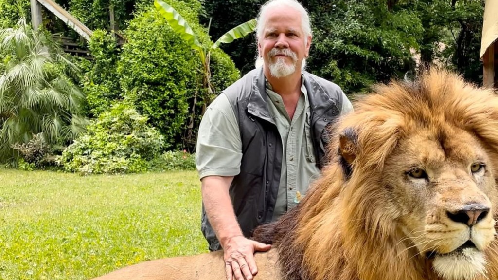 Doc Antle posing with a lion