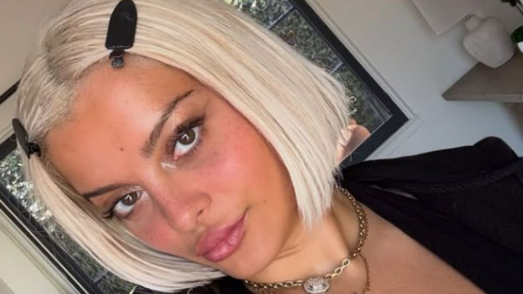 Bebe Rexha’s Lacy Plunge Top Comes With a Detail That’s Hard To Ignore