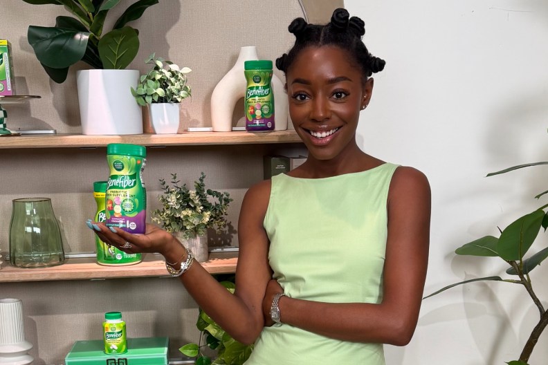 Venita Aspen holding a jar of Benefiber