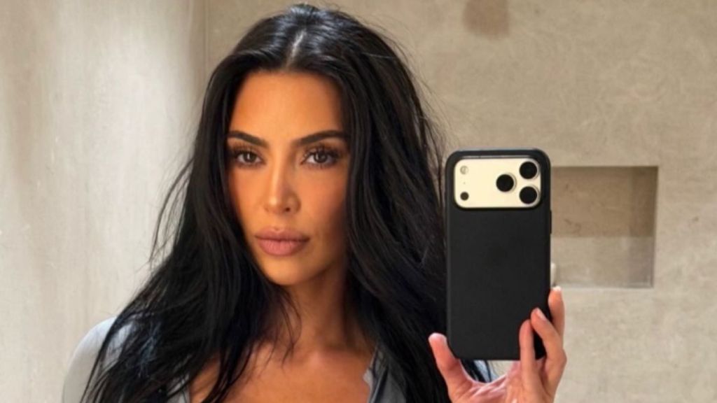 Kim Kardashian Flashes a Hint of Bra in Her Unbuttoned Shirt