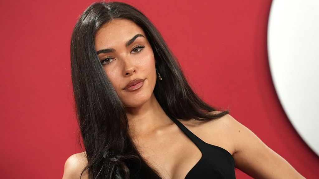 Madison Beer Adjusts Thin Straps of Her Plunging Minidress in New Photo