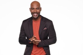 Karamo Brown in a red shirt and black suit for Season 3 of Karamo