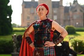 Alan Cumming in red tartan posing with his hands on his hips on The Traitors Season 4