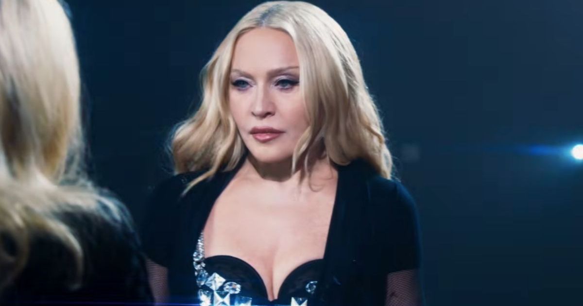 Madonna Twists & Turns on Table in Plunging Bodysuit